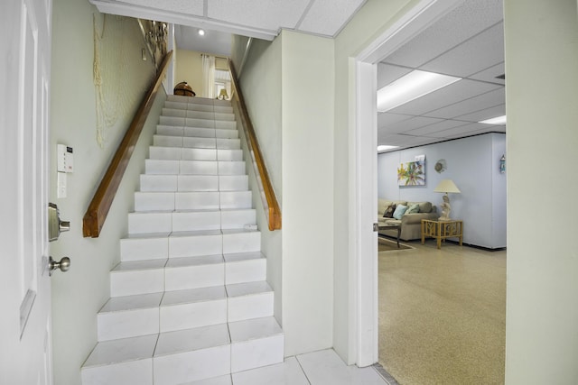 stairs featuring a paneled ceiling