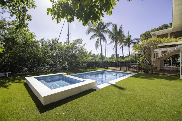 view of pool featuring a lawn