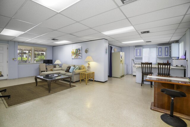 living room featuring a drop ceiling