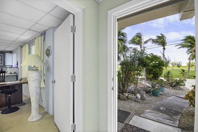 hallway with a paneled ceiling