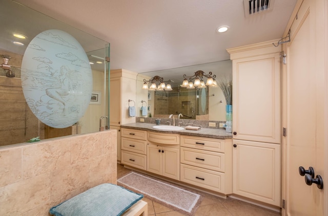 bathroom featuring vanity, tile patterned flooring, and a shower with door