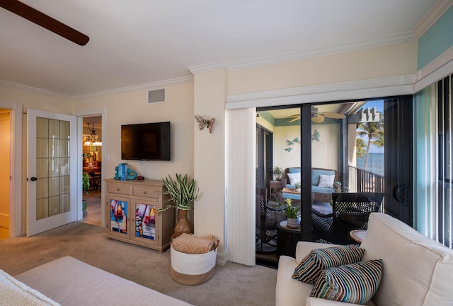 carpeted living room featuring crown molding and ceiling fan