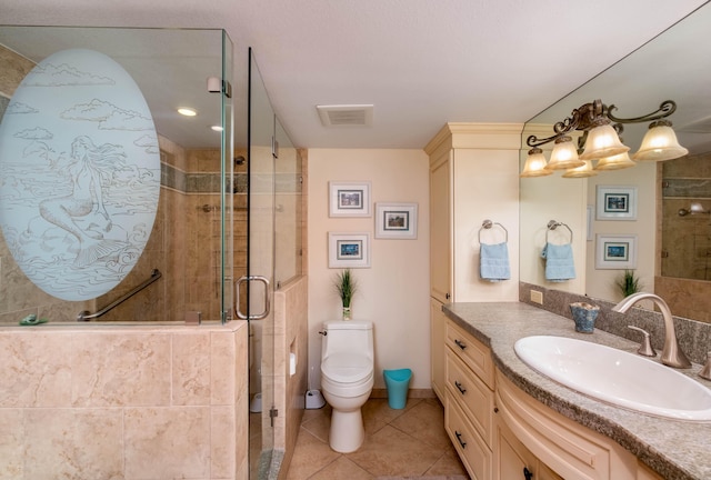 bathroom featuring tile patterned flooring, vanity, toilet, and walk in shower