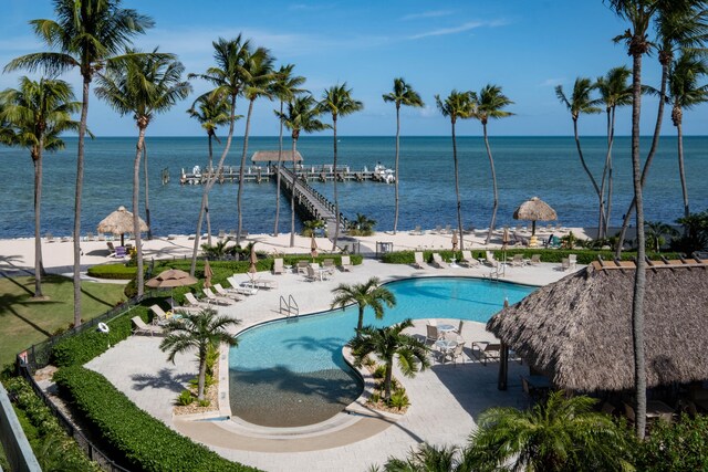 view of pool with a water view and a patio area