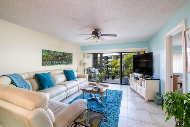 living room featuring light tile patterned floors, a textured ceiling, and ceiling fan