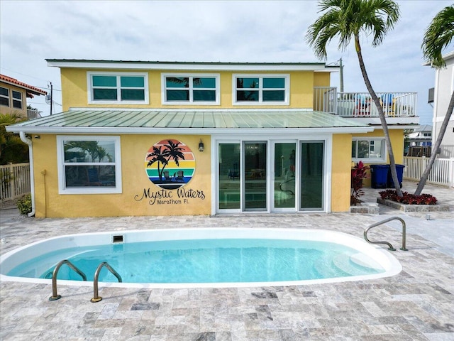 rear view of property featuring a balcony