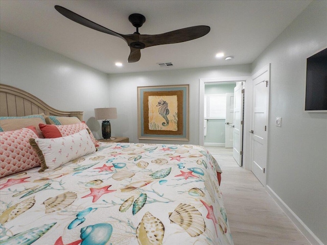 bedroom featuring connected bathroom, ceiling fan, and light hardwood / wood-style flooring