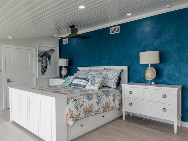 bedroom featuring vaulted ceiling and light wood-type flooring