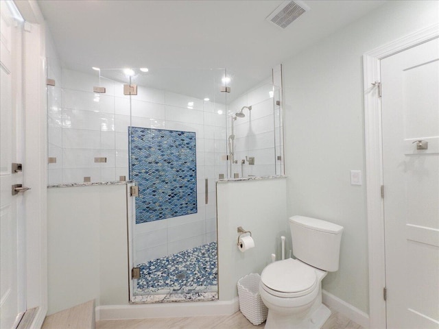 bathroom with toilet and walk in shower