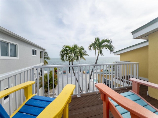 wooden terrace featuring a water view