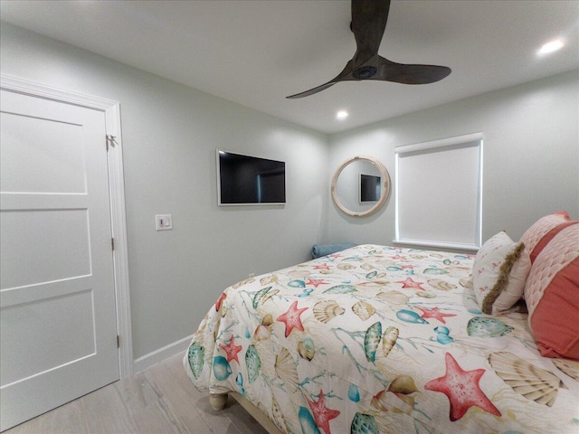 bedroom with light hardwood / wood-style flooring and ceiling fan