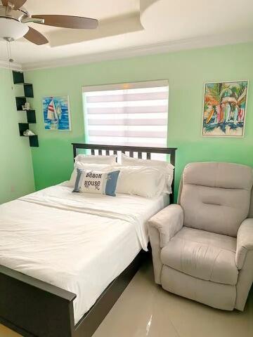 bedroom with crown molding and ceiling fan