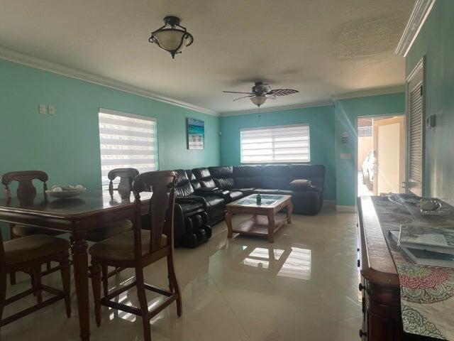 dining area with ceiling fan and ornamental molding