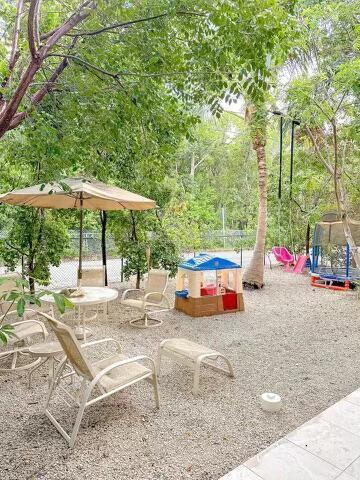 view of property's community featuring a playground and a trampoline