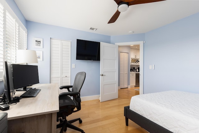 bedroom featuring light wood-type flooring, a closet, and ceiling fan