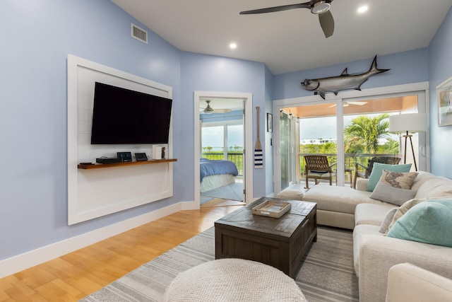 living room with hardwood / wood-style floors and ceiling fan