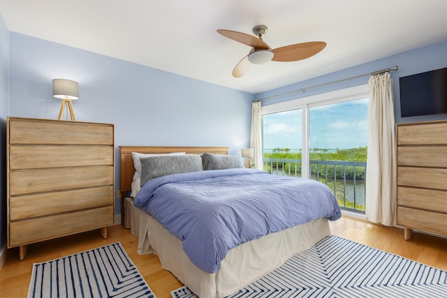 bedroom featuring access to exterior, ceiling fan, and light hardwood / wood-style flooring