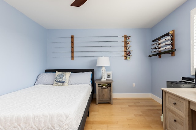 bedroom with light wood-type flooring and ceiling fan