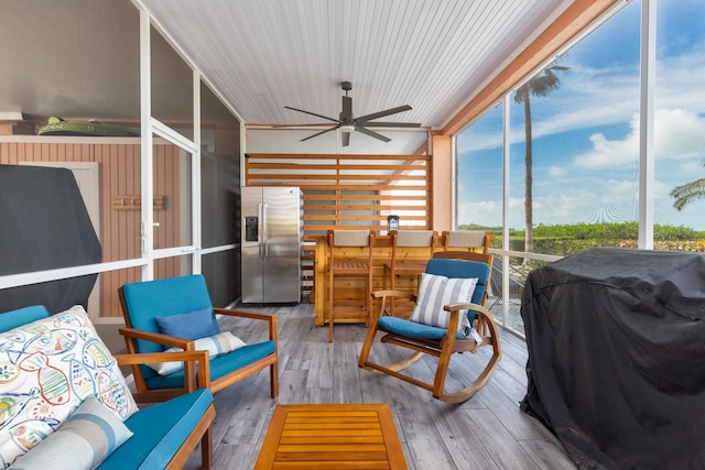 sunroom / solarium featuring ceiling fan