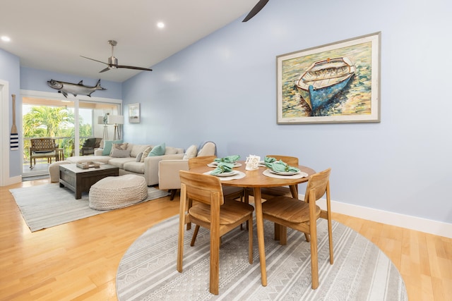 dining space with wood-type flooring, lofted ceiling, and ceiling fan