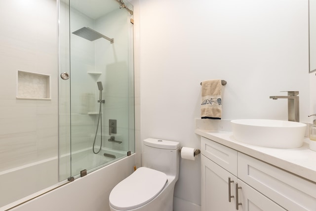 full bathroom featuring vanity, toilet, and enclosed tub / shower combo