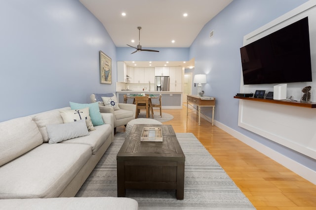 living room with hardwood / wood-style flooring and ceiling fan