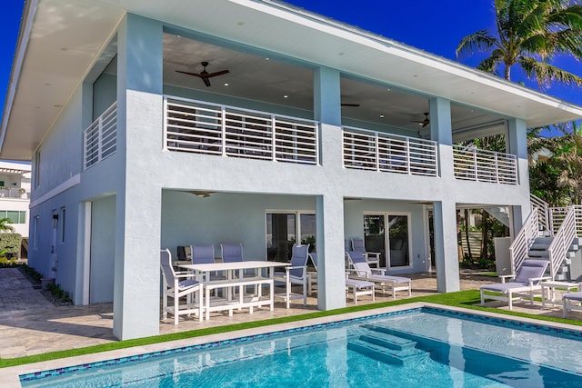 rear view of property featuring ceiling fan and a patio area