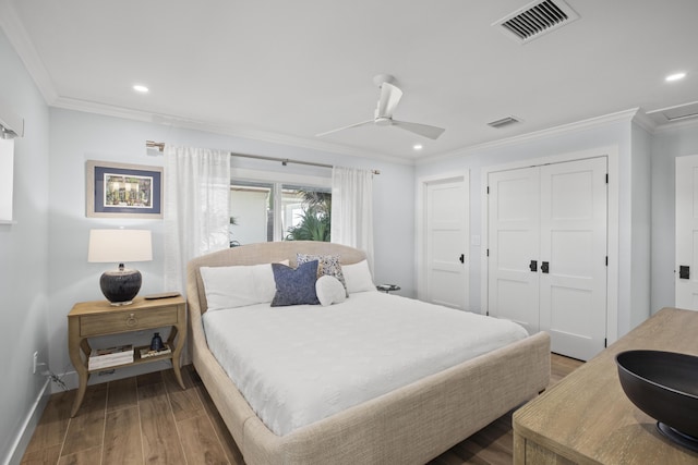 bedroom featuring ornamental molding, wood-type flooring, ceiling fan, and a closet