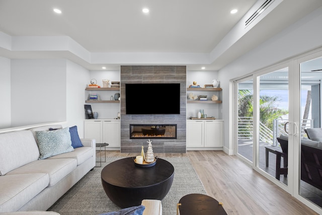 living room featuring a fireplace and light wood-type flooring