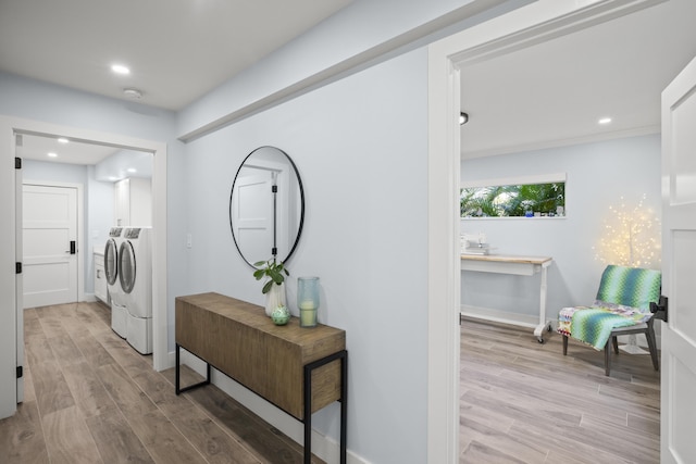 hallway with washer and dryer and light wood-type flooring