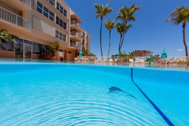 view of swimming pool with fence