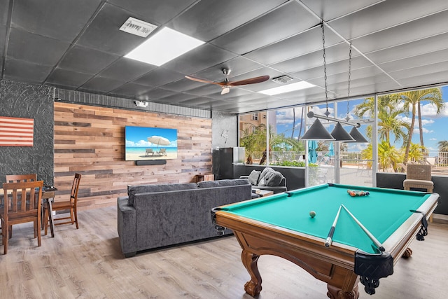 playroom featuring light wood-style floors, a healthy amount of sunlight, and visible vents