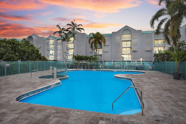 view of pool at dusk