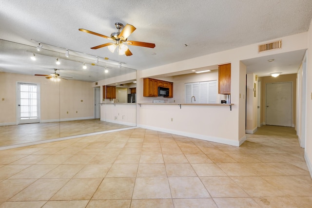 3930 S Roosevelt Blvd Unit N302, Key West, FL 33040 - unfurnished living room with a textured ceiling, a ceiling fan, light tile patterned flooring, baseboards, and a sink
