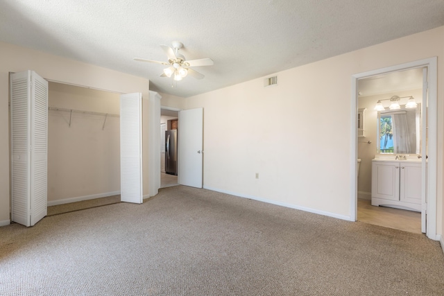 3930 S Roosevelt Blvd Unit N302, Key West, FL 33040 - unfurnished bedroom featuring stainless steel refrigerator with ice dispenser, carpet flooring, a closet, baseboards, and a textured ceiling