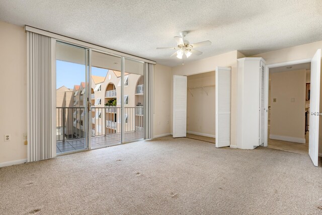 3930 S Roosevelt Blvd Unit N302, Key West, FL 33040 - unfurnished bedroom with access to exterior, carpet, a closet, a textured ceiling, and a ceiling fan