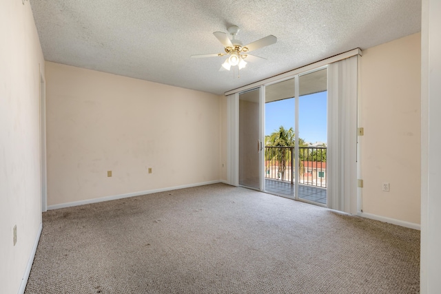 3930 S Roosevelt Blvd Unit N302, Key West, FL 33040 - carpeted spare room featuring a ceiling fan, a textured ceiling, expansive windows, and baseboards