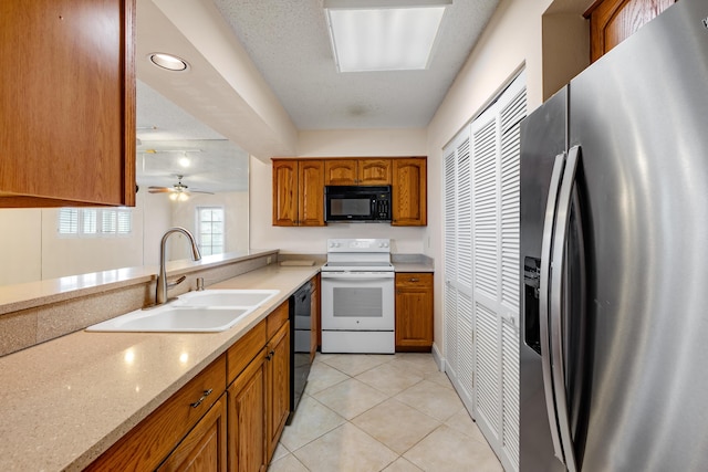 3930 S Roosevelt Blvd Unit N302, Key West, FL 33040 - kitchen featuring black appliances, a sink, brown cabinetry, and light tile patterned floors