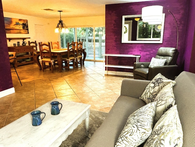 living area featuring visible vents, tile patterned floors, and a chandelier