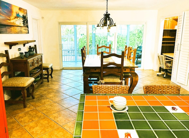 tiled dining space with a notable chandelier and a wealth of natural light