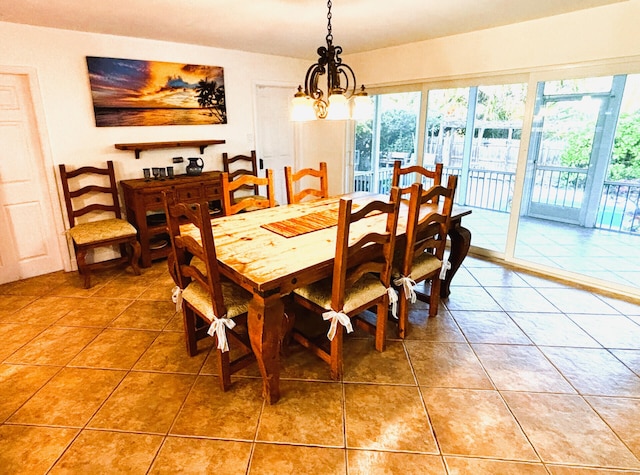 dining room featuring a chandelier and light tile patterned flooring