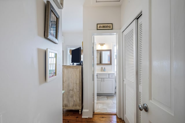 corridor featuring sink and hardwood / wood-style floors