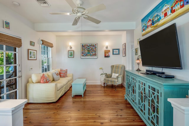 living room with wood-type flooring and ceiling fan