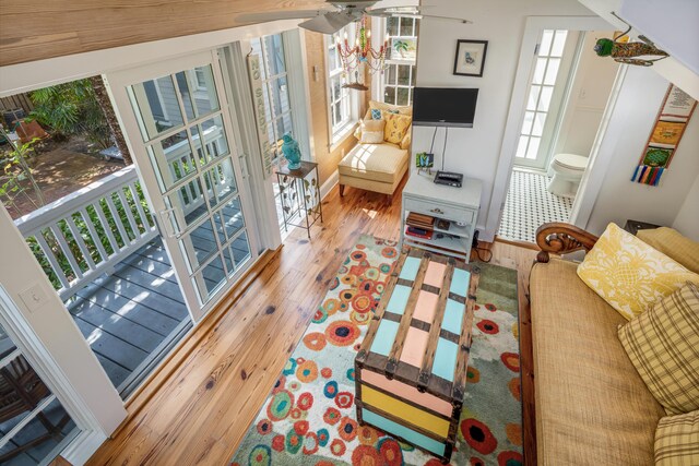 living room featuring wood-type flooring and ceiling fan