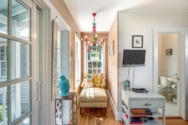 sitting room featuring plenty of natural light, a chandelier, and hardwood / wood-style floors