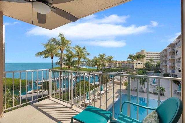 balcony with a water view and ceiling fan