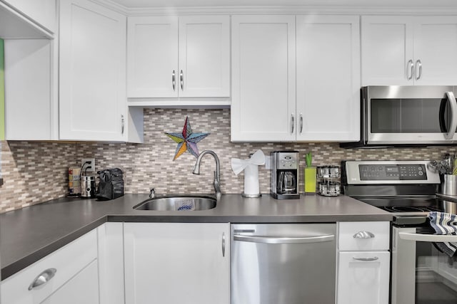 kitchen featuring white cabinetry, stainless steel appliances, sink, and tasteful backsplash