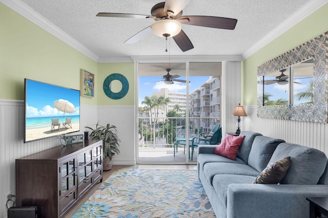 living room featuring expansive windows, ornamental molding, hardwood / wood-style flooring, and a textured ceiling