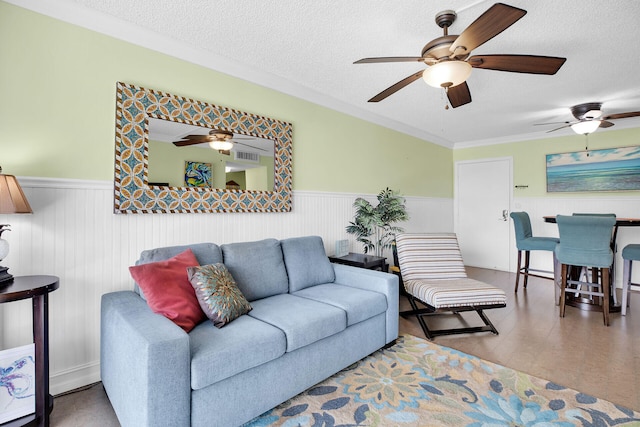 living room with ornamental molding, wood-type flooring, and a textured ceiling