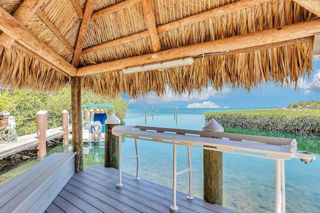 view of dock featuring a gazebo and a water view